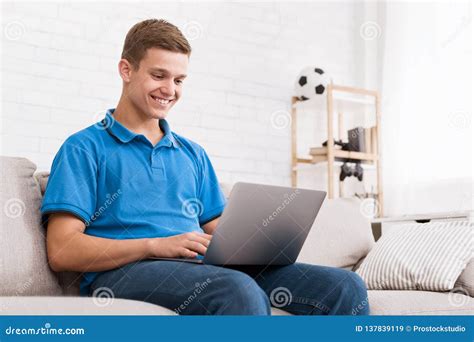Teen Guy Surfing Internet On Laptop At Home Stock Image Image Of Couch Looking 137839119