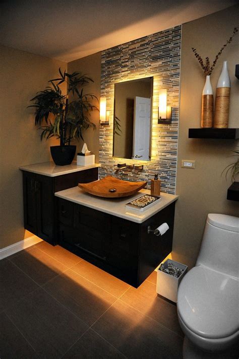 A Bathroom With A Toilet Sink And Mirror In Its Center Area