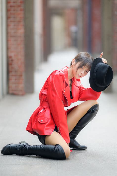 Asian Brunette girl Hands Décolletage Shorts Legs Wearing boots