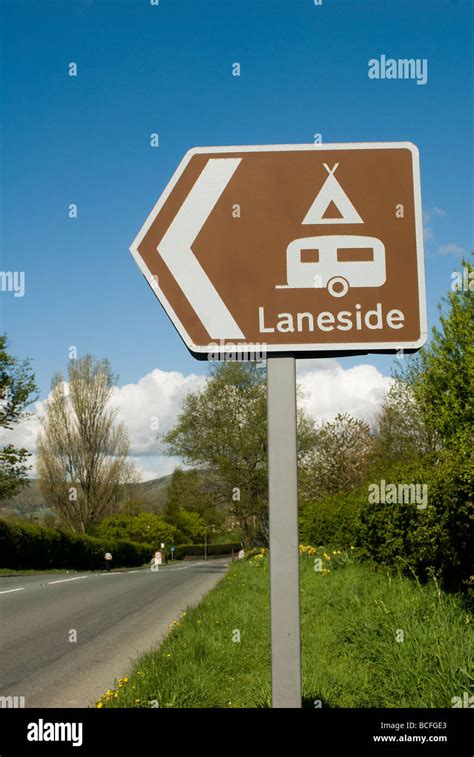 Brown Road Sign Showing The Way To A Camping And Caravanning Site In