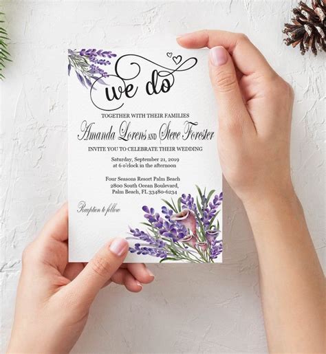 Two Hands Holding Up A Wedding Card With The Word We Do Written On It