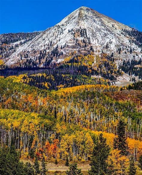 A Freshly Dusted Hahns Peak Looks Over A Hillside Of Fall Foliage In