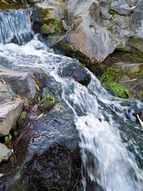 A Small Stream Flowing Over Some Rocks Stock Photo Colourbox