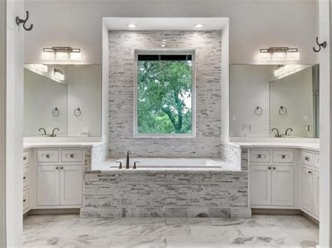 I've thought to tile the entire wall, or just where to end this kitchen backsplash? Love this tile backsplash around the tub...really frames ...