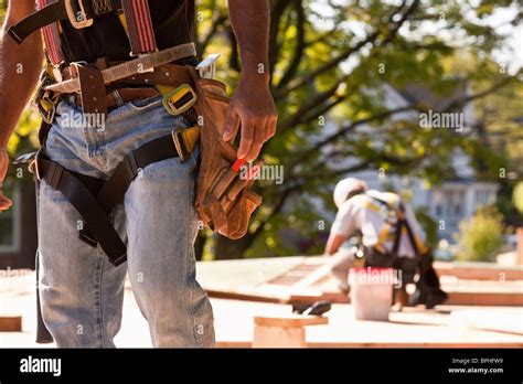 Carpenters working at a construction site Stock Photo - Alamy