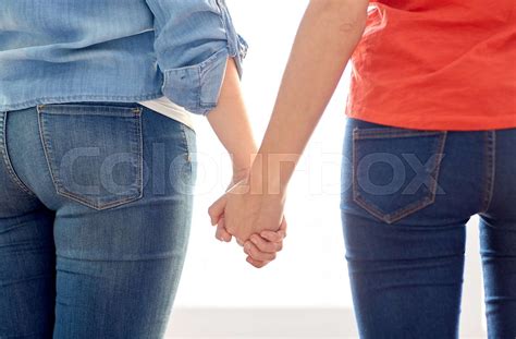 close up of lesbian couple holding hands stock image colourbox