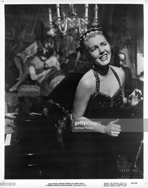 Jean Arthur Near Piano In A Scene From The Film A Foreign Affair