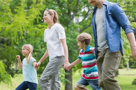 Parents And Kids Walking In Park High Quality Stock Photos Creative