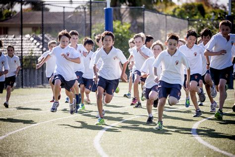 Boys Running On The Junior School Oval Brighton Grammar Leading