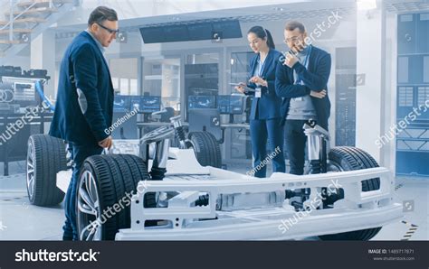 Automotive Design Engineers Talking While Working Stock Photo