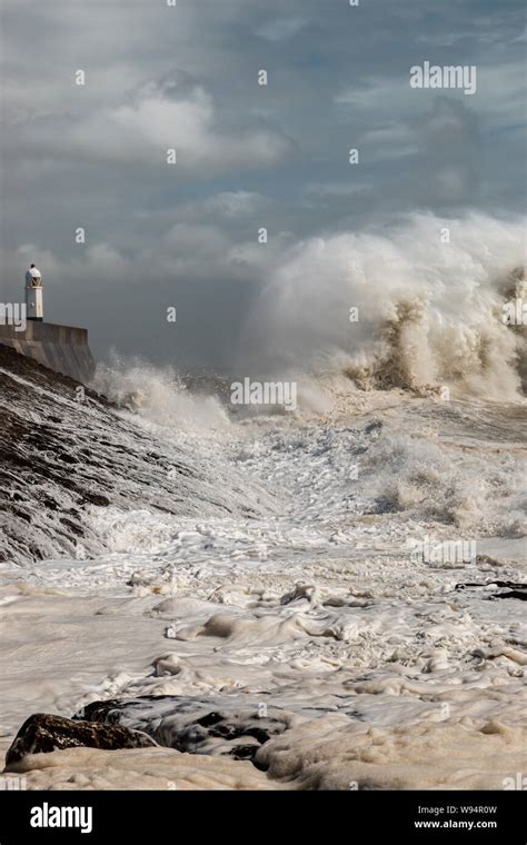 Huge Breaking Waves Next To A Lighthouse On A Stormy Day Porthcawl