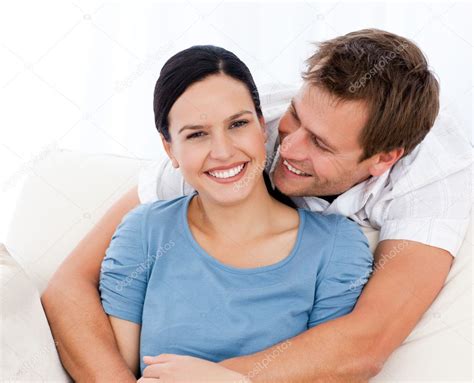 Passionate Man Hugging His Girlfriend While Relaxing On The Sofa Stock