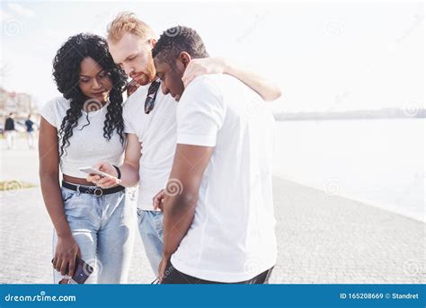 Group Of Multiracial Happy Friends Using Gadget Outdoors Concept Of