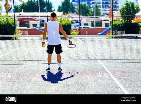 Senior Tennis Player Playing Tennis Outdoors Im Sunny Day Stock Photo