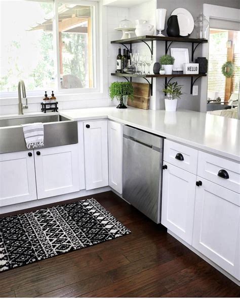 Popular white kitchen cabinets gleam with pizzazz, do you agree? Black & White Neutral Kitchen with shaker cabinets, black hardware, stainless steel farmhouse ...