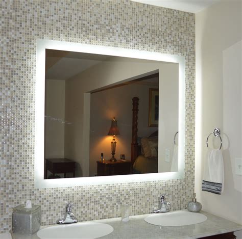 A Bathroom With Two Sinks And A Large Mirror In Its Center Along With