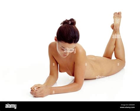 Nude Female Lying On Front On Flotowards Camera Legs Up Feet Crossed Leaning Up On Elbows Head