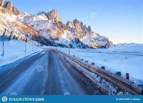 Icy Mountain Pass Road In A Majestic Snowy Mountain Scenery At Sunset