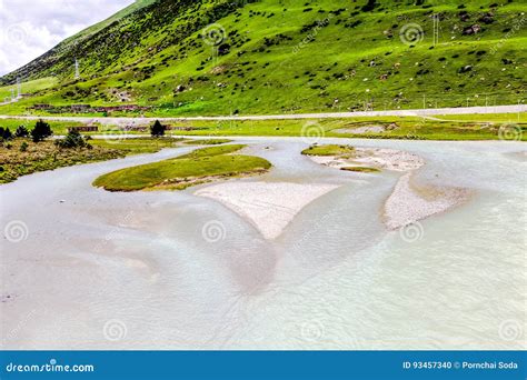 The River And Green Mountain Landscape At Tibet China Stock Photo