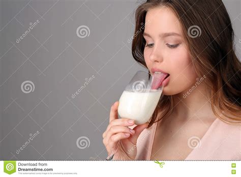 Girl Licking Milk From A Wine Glass Close Up Gray Background Stock