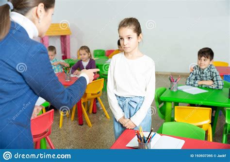 Female Teacher Scolding Naughty Student In Elementary School Class