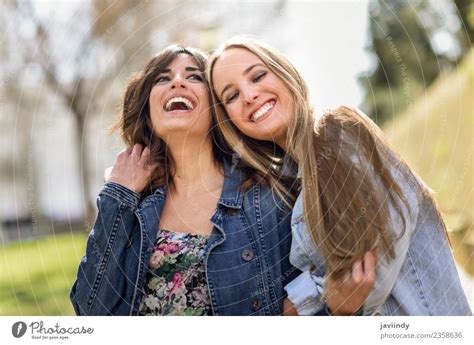 Two Happy Young Women Friends Hugging In The Street A Royalty Free