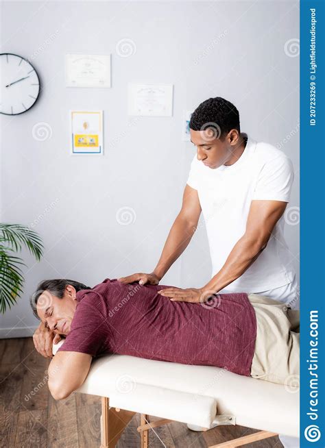 African American Masseur Massaging Back Of Stock Image Image Of Handsome Masseur 207233269