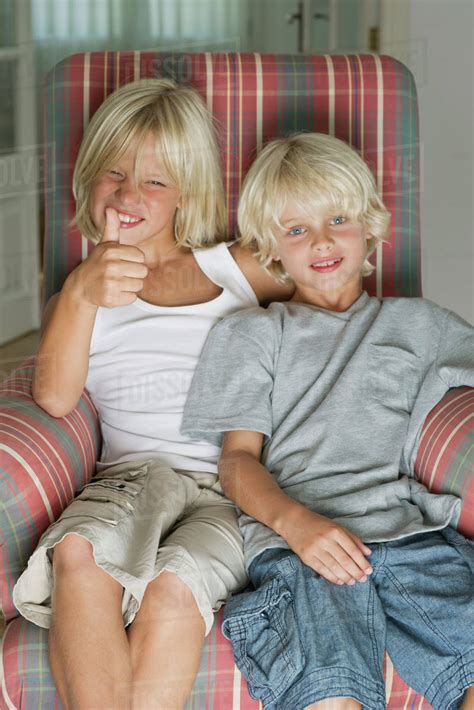 Brothers Sitting In Armchair Portrait Stock Photo Dissolve