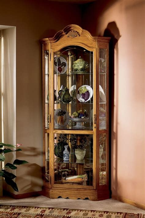The bowery hill lighted corner curio cabinet has a tall simple design with an arch at the top. Classic Lighted Corner Curio Cabinet for Family Heirlooms ...
