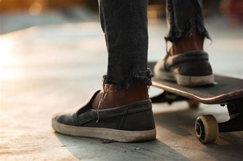 Free Photo Close Up Of Skateboarders Feet Skating