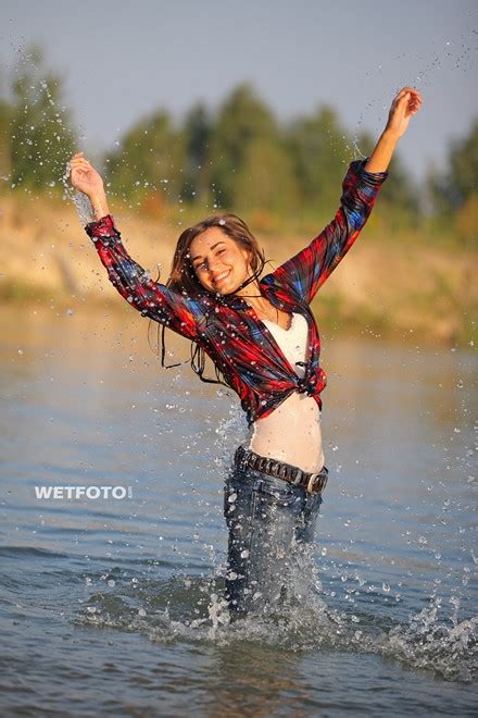 Wetlook By Pretty Girl In Shirt Tight Jeans And White Sneakers On Lake