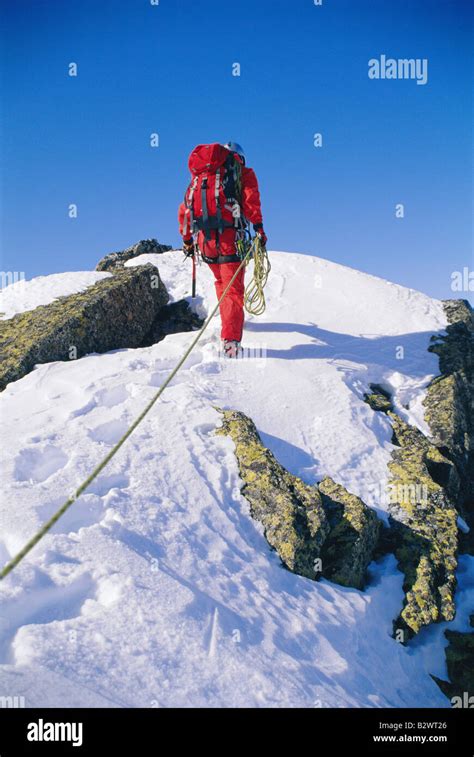 Mountain Climber Walking On Snowy Mountain Stock Photo Alamy