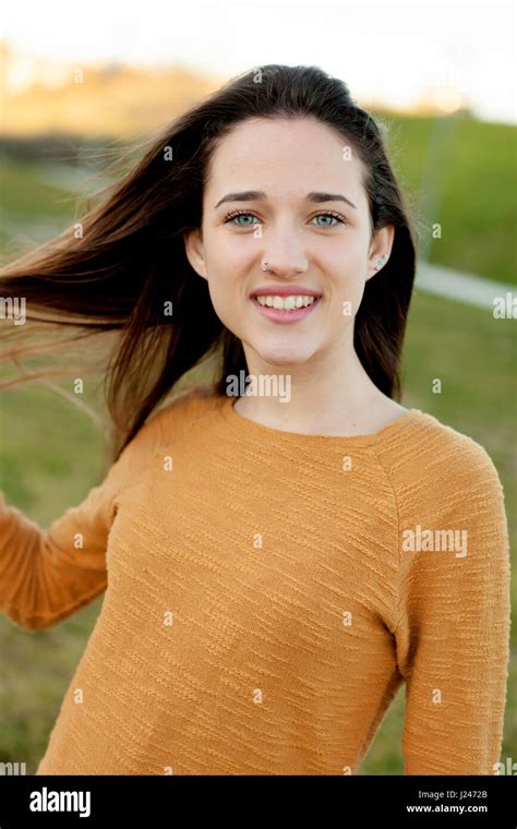 Outdoor Portrait Of Beautiful Happy Teenager Girl Laughing While The