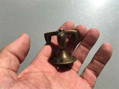 It comes with screws and anchors. 8 small Vintage spinning deco solid BRASS wardrobe HOOKS ...