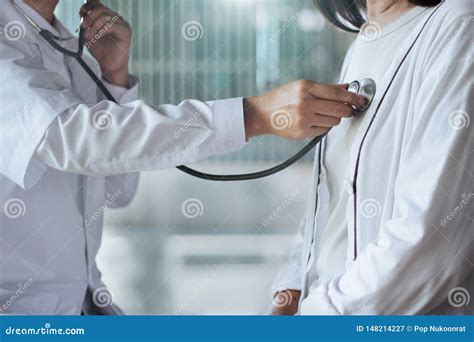 Doctor Using Stethoscope Checking Heart Rate For Elderly Patients In Hospital Stock Image