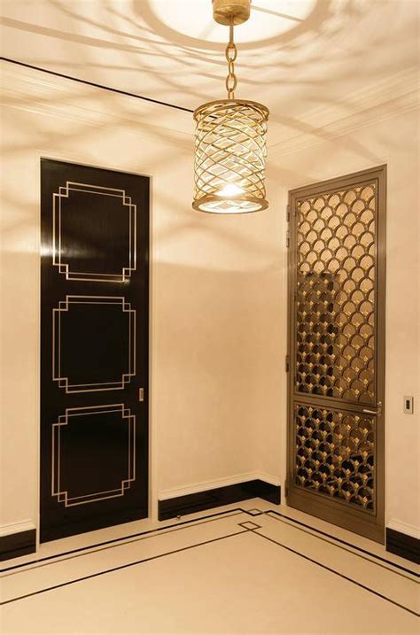 Some historians feel that the greek key its basis in the greek myth of the labyrinth that imprisoned the minotaur. Hollywood Regency Foyer with Black Art Deco Door ...