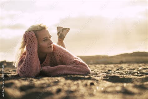 Beautiful Model Lay Down On The Sand At The Beach Enjoying Relax Golden Sunset Outdoor Leisure