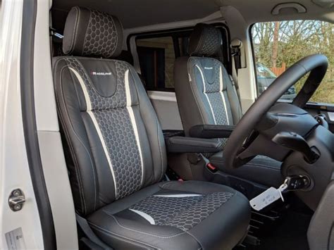 The Interior Of A White Van With Black Leather Seats