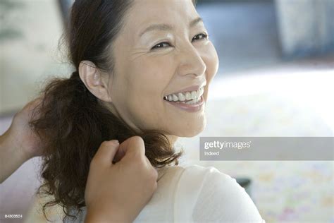 Mature Woman Receiving Shoulder Massage Smiling Photo Getty Images