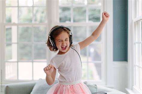 Cute Young Girl Listening To Music Wearing Headphones By Stocksy