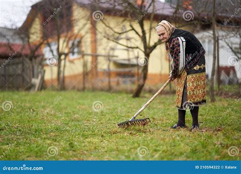 Old Farmer Woman Cleaning With A Rake Stock Photo Image Of Embroidery