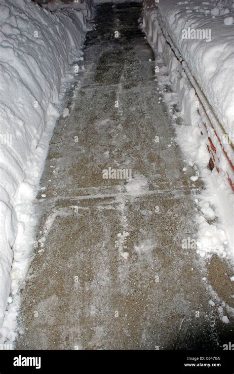 Shoveled Sidewalk In Deep Snow With Snow Melt Particles Stock Photo Alamy