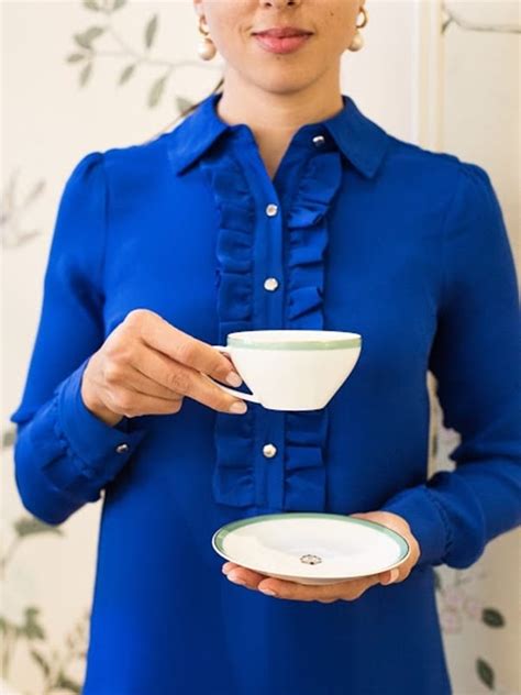 A Beaumont Etiquette Holding Tea Cup Saucer Vertical Myka Meier The