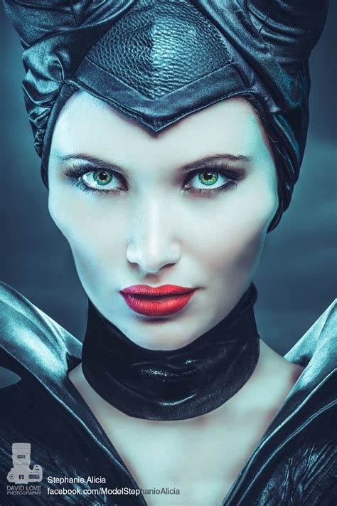 A Woman With Horns On Her Head And Green Eyes Is Wearing Black Leather Gloves Red Lipstick