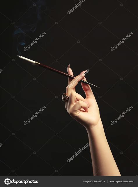 Female Hand With Cigarette Holder Stock Photo By ©belchonock 148527319