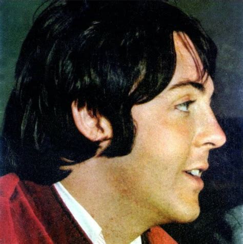 A Close Up Of A Person Wearing A Red Jacket And Tie With His Eyes Closed