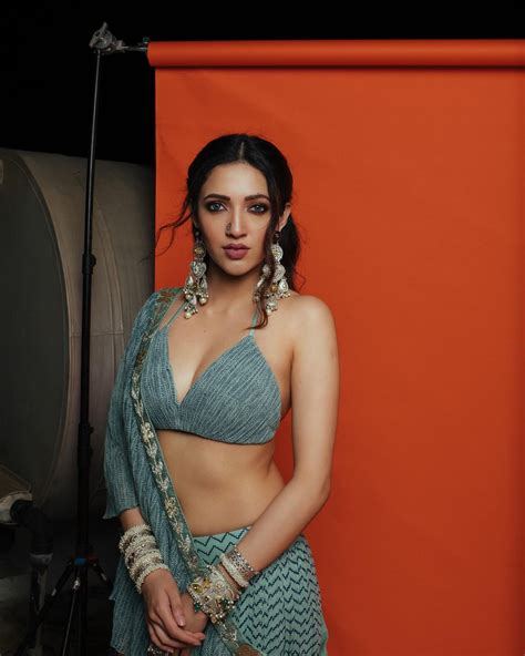 dj tillu actress neha shetty looks sizzling hot in this saree with tiny bralette see new photos