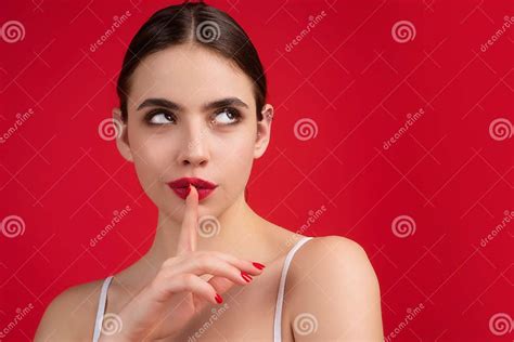 Young Woman Having Secret While Holding Finger On Lips And Showing