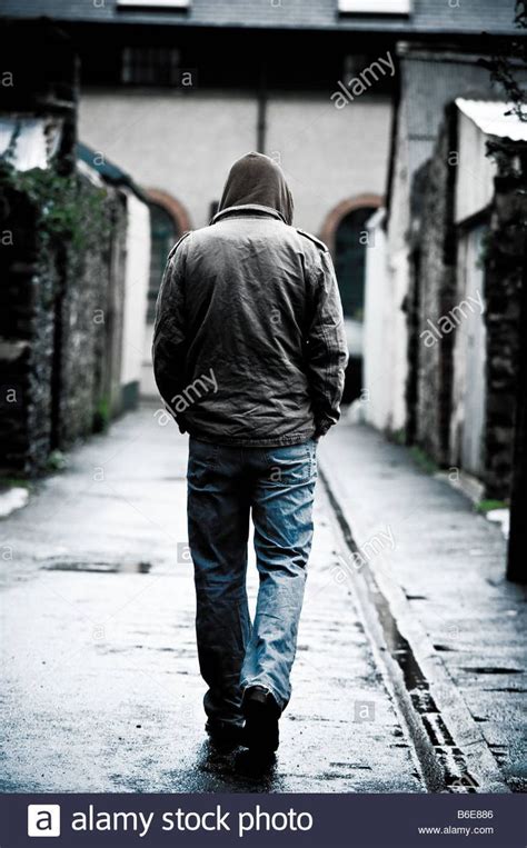Download This Stock Image Young Man Wearing A Hooded Jacket Alone And