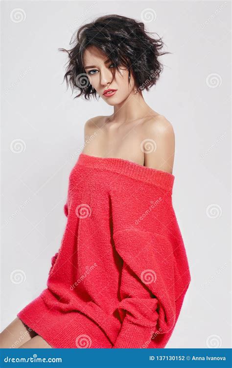 Naked Woman With Short Hair Girl Posing In A Red Sweater On A White